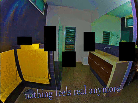A photograph of the interior of a bathroom, shot using a fisheye lens. There are cabinets to the right, a vent or drying rack of some description in the centre, and a shower with yellow towels to the left. Sparkling text at the bottom of the screen reads, 'nothing feels real anymore'.